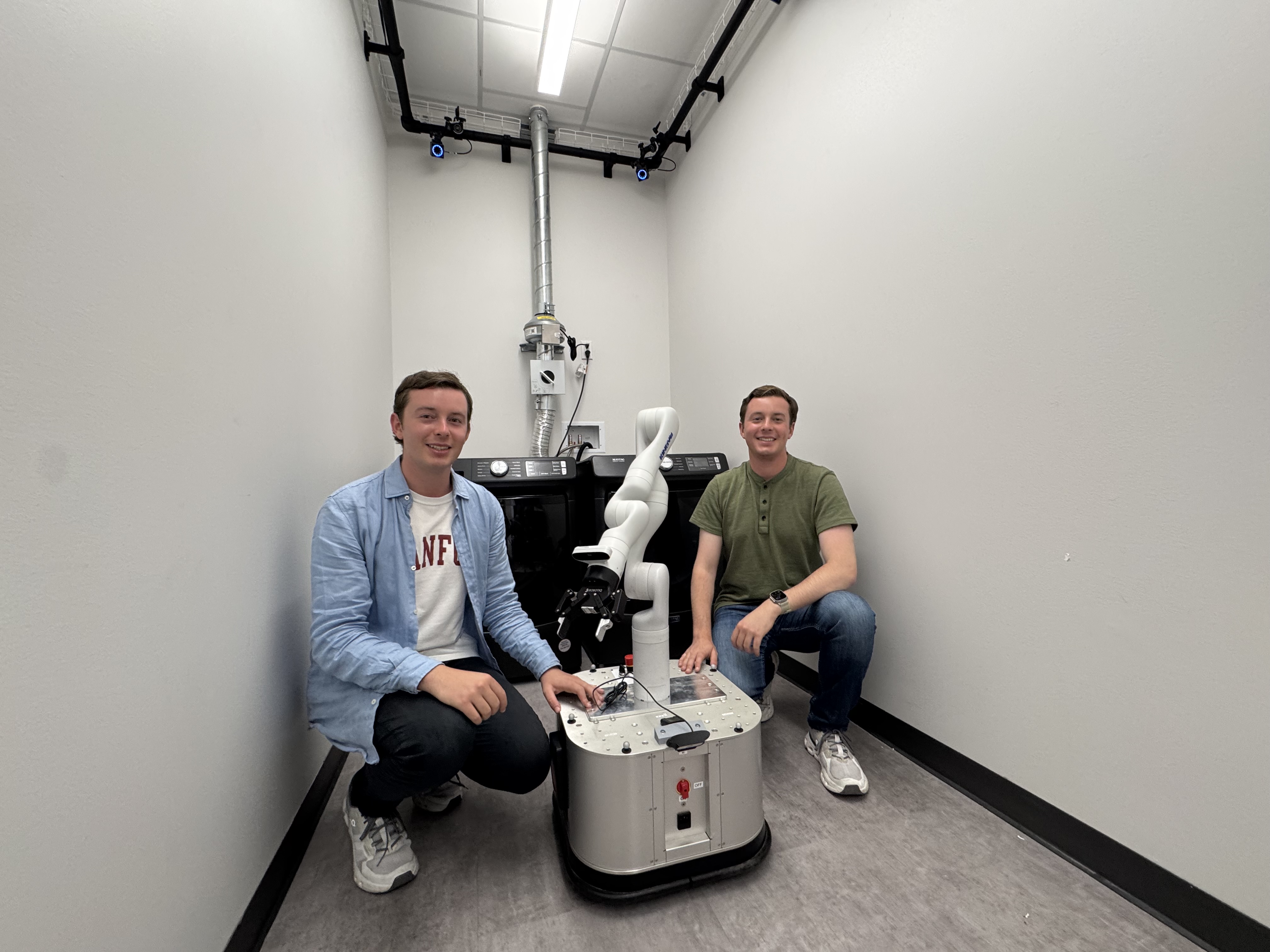 Mark and Andrew Ansell with robotic arm in laboratory